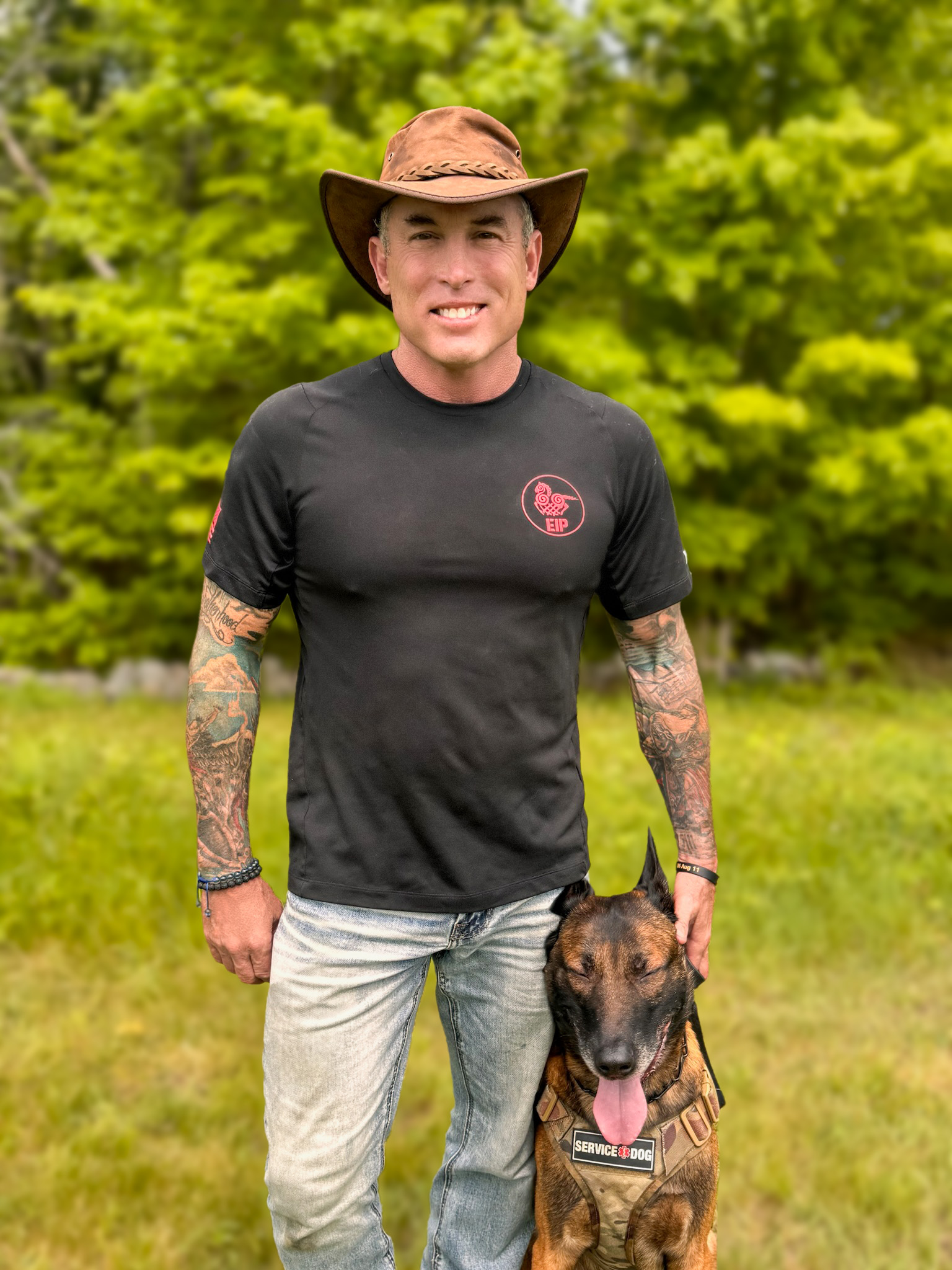 US Male Veteran standing with service dog