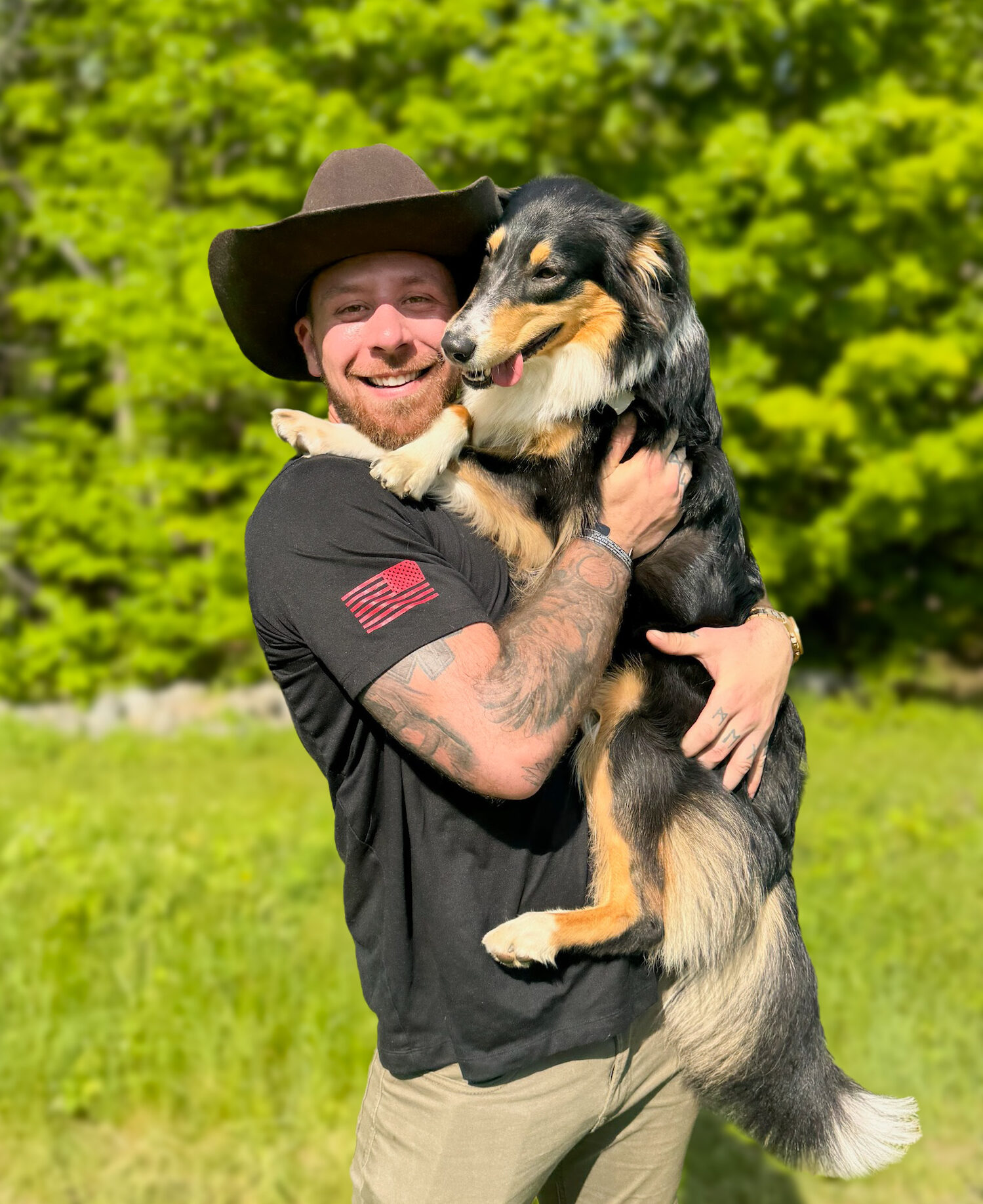 US Male Veteran holding sheppard dog